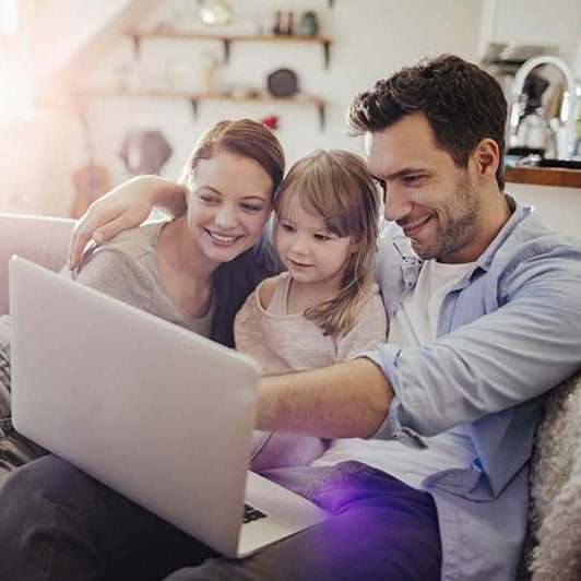 Family sitting on a couch together 