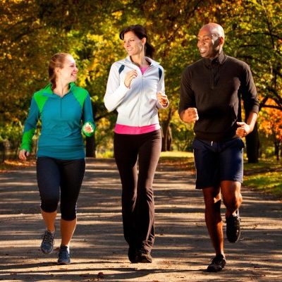 Three people walking in a park 