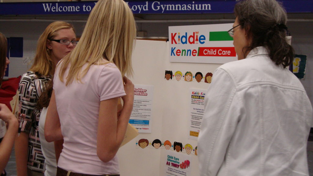 Student showing teachers a Child Care presentation